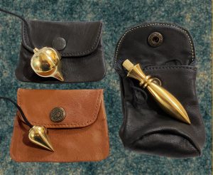 Small and large pendulum pouches with pendulums showing.